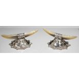 A pair of Edwardian silver and mother-of-pearl knife rests, designed as a pair of horns on a