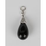 A black onyx and diamond pendant, the black onyx drop with a diamond set cap and a marquise shaped