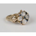 A 9ct gold, sapphire and moonstone cluster ring, mounted with five circular cut sapphires and four