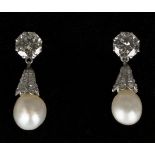 A pair of diamond and natural saltwater pearl pendant earrings, each top claw set with a circular