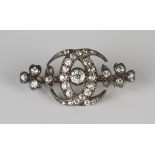 A Victorian gold backed and silver set diamond brooch, designed as two interlinked crescents and a