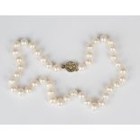 A single row necklace of freshwater cultured pearls on a snap clasp, length 41cm, a single row