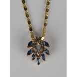 A 9ct gold and sapphire pendant of pierced heart shaped form, mounted with seven marquise shaped