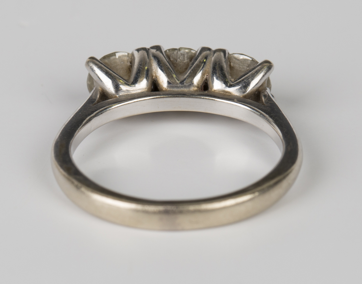 An 18ct white gold and diamond three stone ring, claw set with a row of circular cut diamonds, - Image 2 of 3