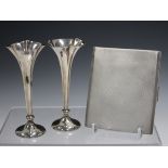 A silver cigarette case, London 1936, and a pair of silver spill vases.Buyer’s Premium 29.4% (