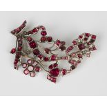 A mid-18th century silver and foil backed flat cut garnet brooch, designed as a spray, mounted