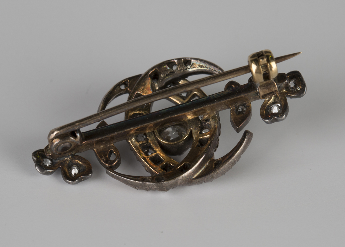 A Victorian gold backed and silver set diamond brooch, designed as two interlinked crescents and a - Image 2 of 3