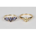 A 9ct gold ring, mounted with three pear shaped Bengal iolites, ring size approx N1/2, with a