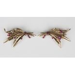 A pair of ruby and diamond brooches, circa 1950s, each designed as a floral and foliate spray,