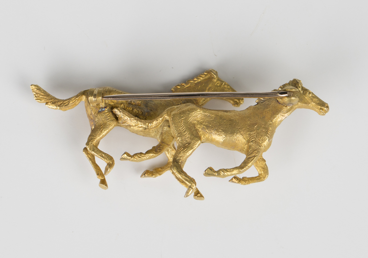 A 9ct gold brooch, designed as two galloping horses, with a textured finish, width 5.5cm, with an - Image 3 of 3