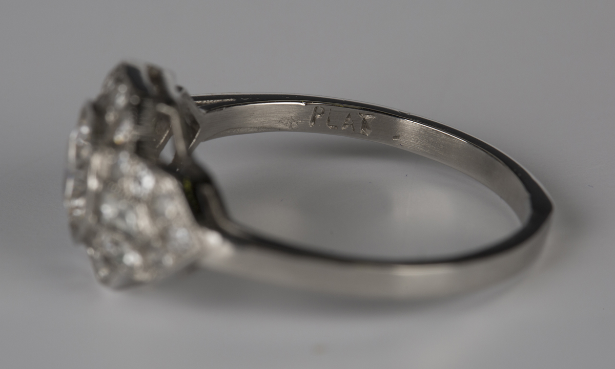 A platinum and diamond ring, collet set with the principal circular cut diamond in a geometric - Image 4 of 4