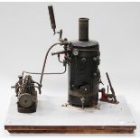 A scratch-built live steam vertical boiler, fitted with a Stuart pressure gauge and a water level