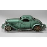 A tinplate Mystery Car, finished in metallic green, length 33cm (playwear, scratch marks and