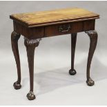 A George II figured mahogany fold-over card table of small proportions, the hinged top above a