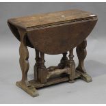A 20th century Carolean Revival oak oval drop-flap occasional table, raised on shaped end supports