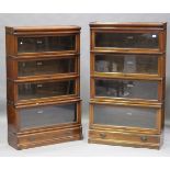 A pair of early 20th century walnut four-section Globe Wernicke library bookcases, each fitted