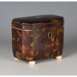 A small Regency tortoiseshell tea caddy, the interior with single lidded compartment, raised on