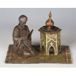 A 20th century Bergman style cold painted cast bronze figure of a kneeling Arabian man beside an