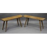 A pair of mid-20th century pine bench stools, possibly Scandinavian, the shaped tops on staked legs,