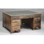 An early 20th century mahogany twin pedestal partners desk, the moulded top above an arrangement