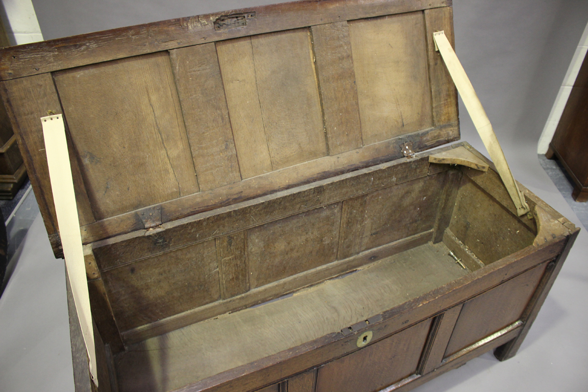 An early 18th century panelled oak coffer with channel moulded decoration, height 68cm, width 141cm, - Image 2 of 4