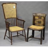 An Edwardian beech framed comb back elbow chair with caned seat and back panel, height 114cm,
