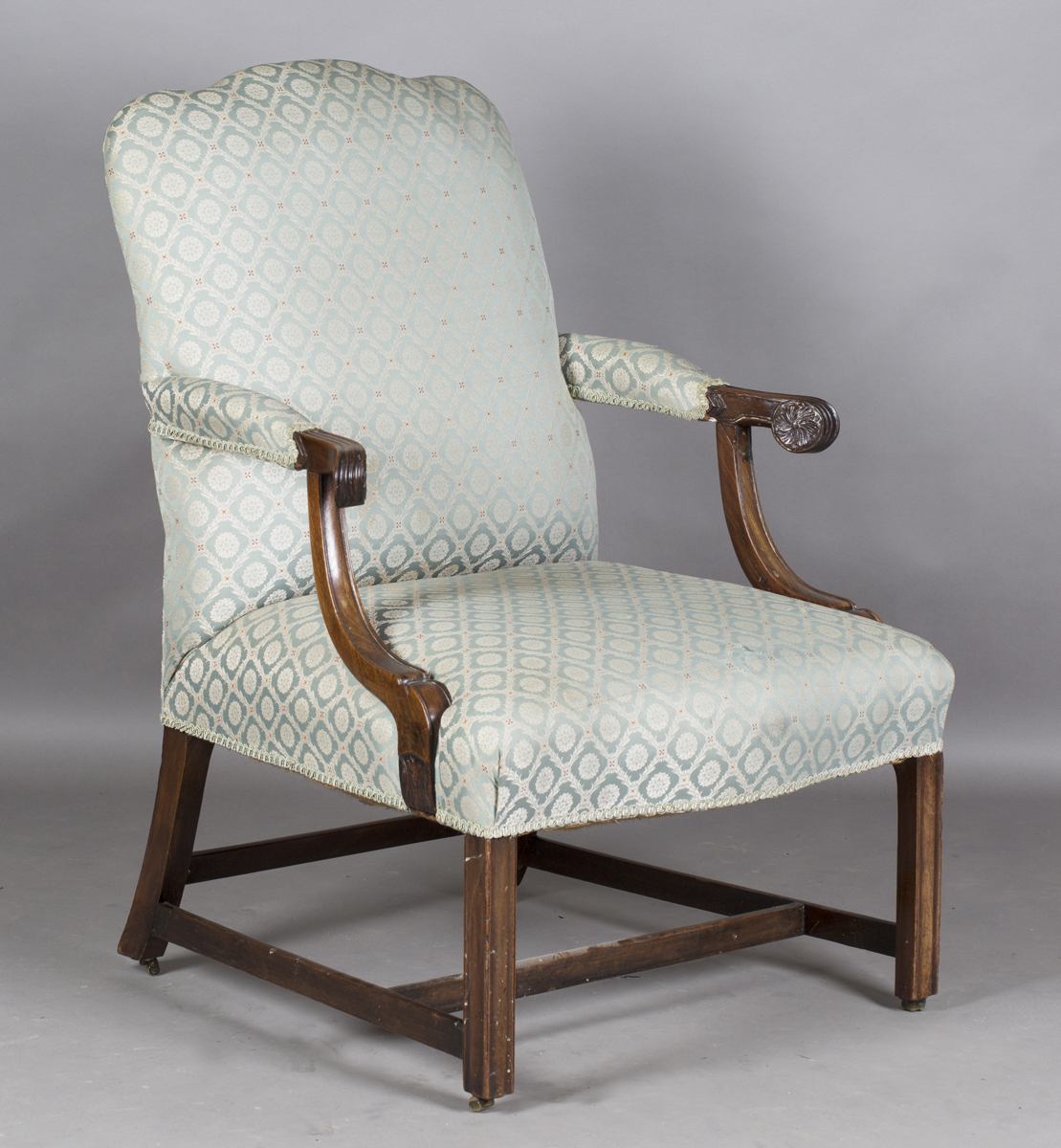A George III mahogany framed Gainsborough style library armchair, upholstered in pale green