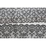 An early 20th century Valenciennes black lace rectangular tablecloth or runner, finely worked with