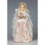 A 19th century Continental carved and painted figure of a kneeling female saint with carved bone