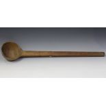 A large carved fruitwood ladle, possibly Corrales, New Mexico, length 82cm.Buyer’s Premium 29.4% (