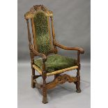 An Edwardian Carolean Revival oak framed elbow chair, the foliate crest detailed 'S.H. & M.L.N. A.