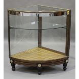 A late 19th/early 20th century walnut and brass framed shop corner display case, one rear side