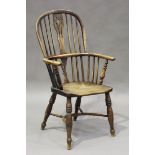 A mid-19th century yew and elm hoop and stick back Windsor armchair with a crinoline stretcher,
