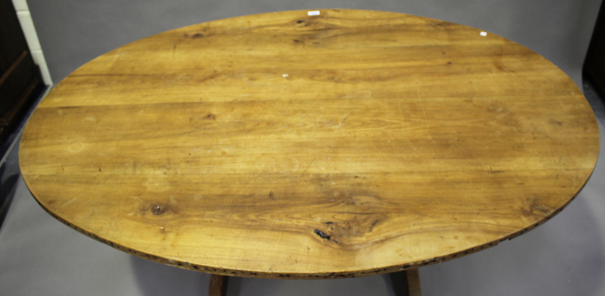 A late 19th century French fruitwood tilt-top vendange or wine tasting table, the oval top on a - Image 2 of 2