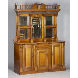 An Edwardian walnut side cabinet, the swan neck and turned balustrade pediment above a concave
