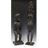 An African carved hardwood full-length figure of a nude male, height 59cm, mounted on a stand,