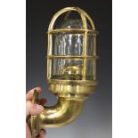 A set of three late 20th century cast brass ship's style wall lights, fitted with glass shades,