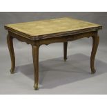 A 20th century French parquetry oak draw-leaf dining table, the shaped rectangular top on cabriole