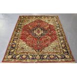 A Central Persian rug, late 20th century, the red field with a shaped blue medallion, within a