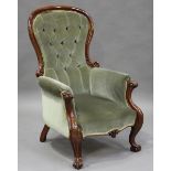 A late Victorian mahogany showframe armchair, raised on carved cabriole legs, height 106cm, width