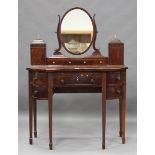 A George IV mahogany dressing table with boxwood stringing, fitted with drawers, cupboards and