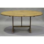 A late 19th century French fruitwood tilt-top vendange or wine tasting table, the oval top on a