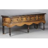 An 18th century and later oak dresser base, fitted with two drawers flanking two later hinged doors,