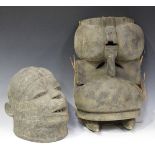 An African carved wooden helmet mask, Makonde tribe, with overall textured surface, height 25cm,