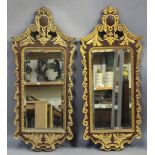 A pair of early 20th century George II style carved mahogany and giltwood wall mirrors, each