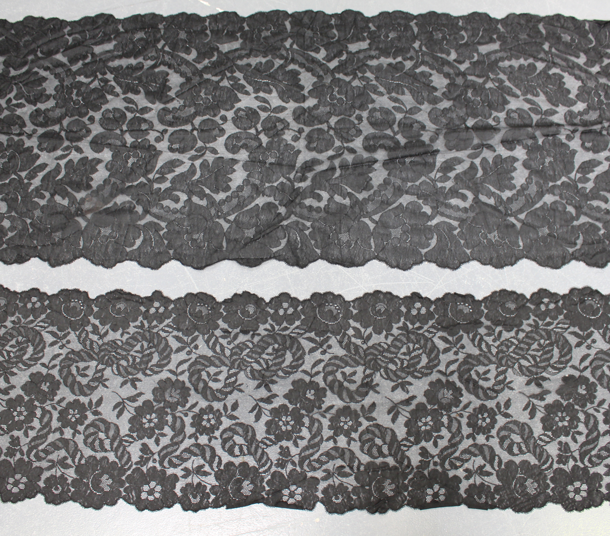 A late 19th/early 20th century Chantilly black lace scarf, finely worked with overall entwined