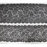 A late 19th/early 20th century Chantilly black lace scarf, finely worked with overall entwined