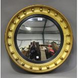 A 19th century convex wall mirror with a ballshot mounted frame, diameter 60cm (repainted gilt).