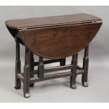 An early 18th century oak drop-flap supper table, the oval top on turned legs, height 70cm, diameter