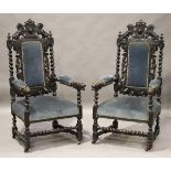 A pair of late Victorian Carolean Revival carved oak armchairs, the backs and handrests carved